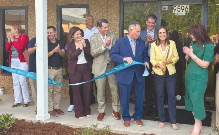 Local government o cials, school board o cials, representatives from parish businesses, and Nunez o cials celebrate the new facility with a ribbon cutting.