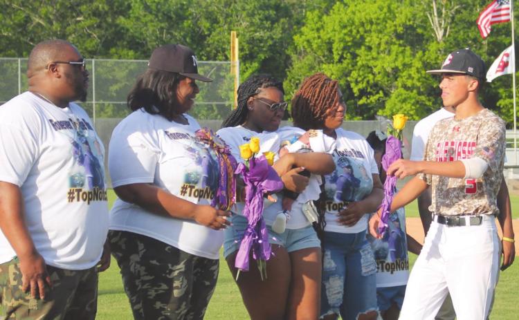 Belle Chasse High School (BCHS) Men’s Baseball Team members and their parents held a ceremony in memory of their former teammate, Keyron “Tootie” Ross, and to honor his mother, Makita Wells-Hartford, at the district playoff game held on Thursday, April 21. Photo by Amber Prattini Wallo