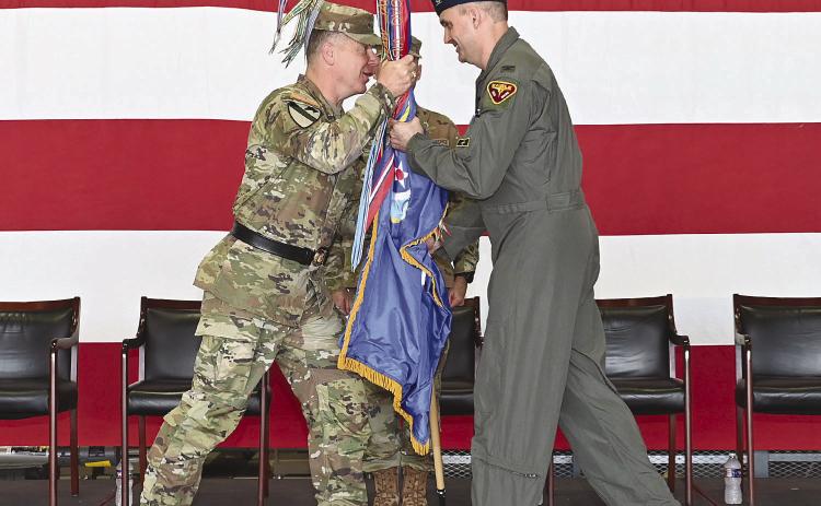 Maj. Gen. Thomas Friloux, the adjutant general of Louisiana, passes the unit guidon to Col. Christopher 'Cli' Ridlon during the 159th Fighter Wing change of command ceremony at Naval Air Station Joint Reserve Base New Orleans, July 11, 2026. The passing of the guidon symbolizes the formal transfer of command. Photo by Technical Sgt. Cindy Au-Wiafe