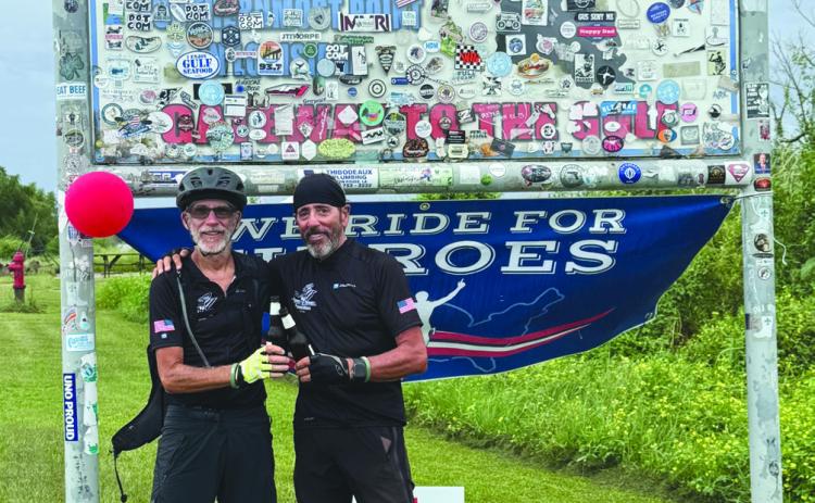 (From left) McCourt and Lipuma celebrating the completion of their 2,500-mile bike ride down the Mississippi River.