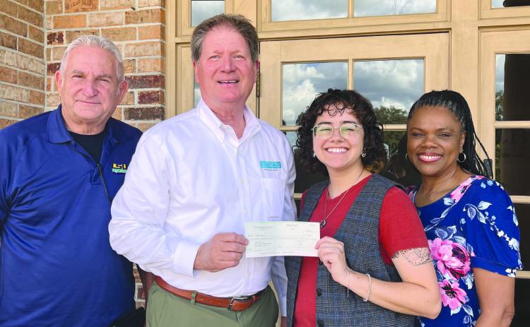 4-H sta Wayne Burgess, Lou Duplantier, and Marlena Cowart receive a donation from George Pivach II of the Venice Port Complex.