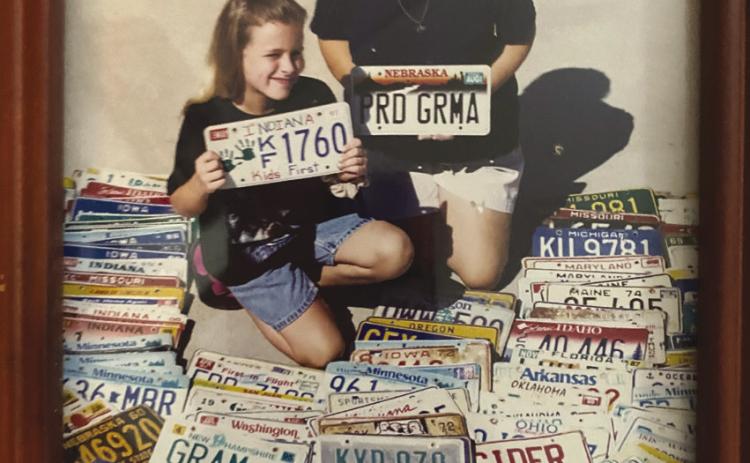 Abbey and Grandmother Glenda with some of license plates donated.