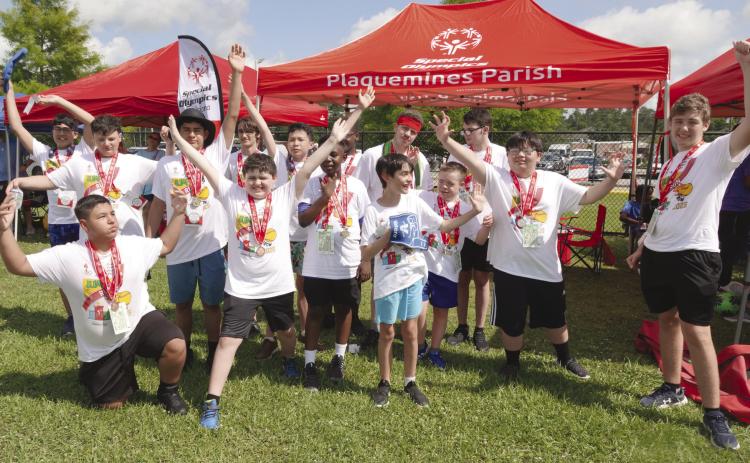 Athletes posing with their medals from the Track and Field competition at the State Summer Games.